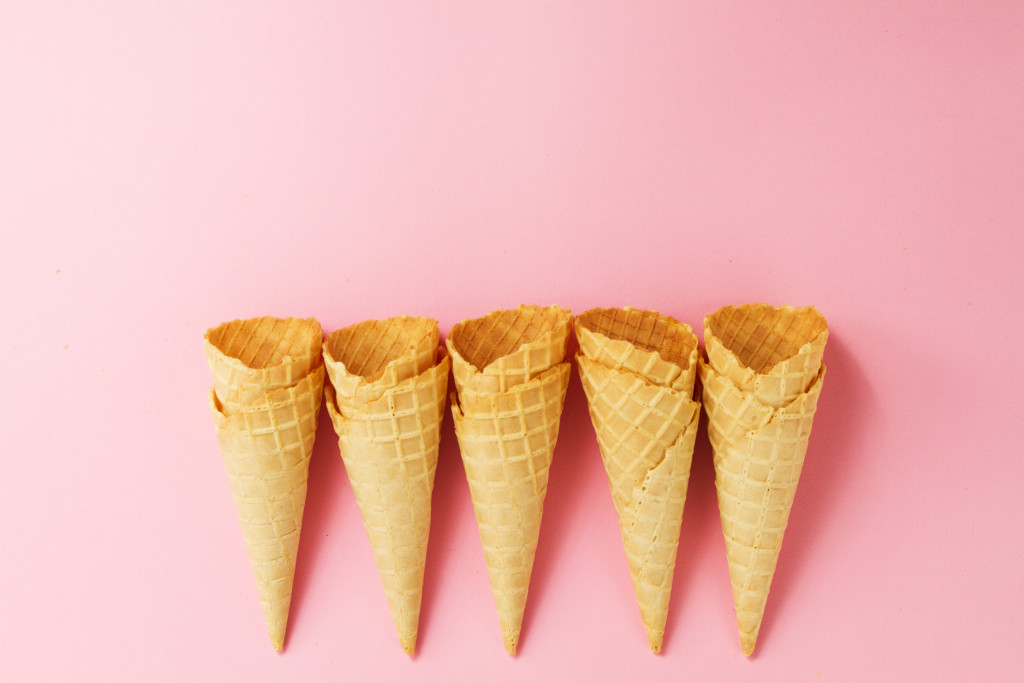 Empty Colorful Ice Cream Cones on Pink Background. Minimalism. Flat Lay.